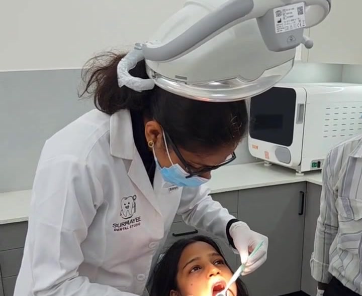 Dr. Surmayee treating a patient at Surmayee Dental Studio, Sector 131, Noida