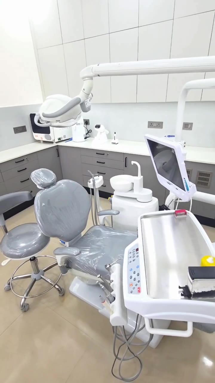 Modern dental treatment room with dental chair at Surmayee Dental Studio, Noida
